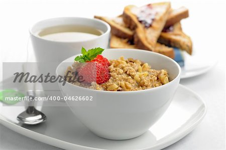 Delicious healthy oatmeal with a cup of tea and toast.