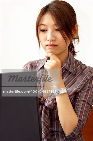 Asian businesswoman, working on her laptop.
