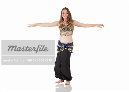 Young Caucasian belly dancing girl in beautiful decorated clothes on white background and reflective floor. Not isolated