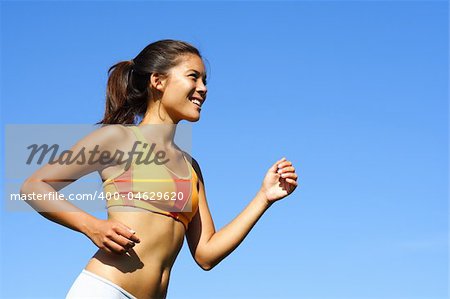 Sporty woman runner in profile on a hot summer day. A lot of copy space.