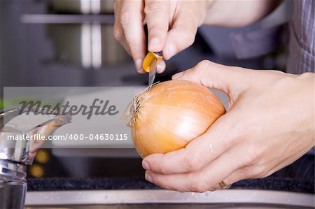 Peeling an onion in a modern kitchen