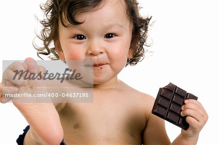 Child eats chocolate, isolated on a white background.