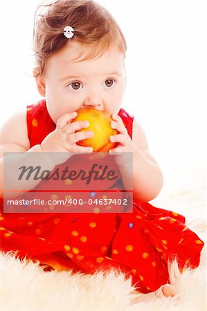 Baby girl with a large peach in hands