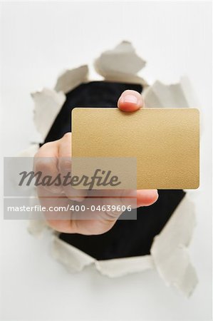 Hand breakthrough wall holding empty golden card - one of the breakthrough series