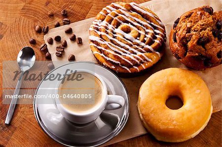 Fresh doughnut and cookies with an espresso