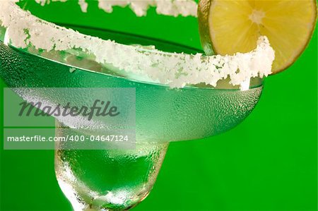 Close up of a cold Margarita glass rimmed with salt and wedged with lime