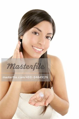 Beautiful brunette young woman applying cosmetic cream in her face