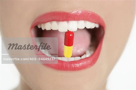 Beauty woman mouth with red lips and medicine pill