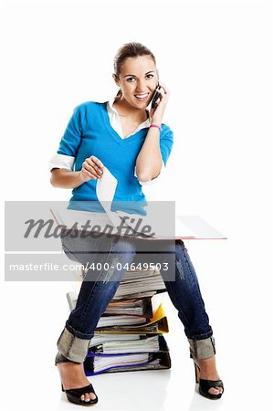 Beautiful female student making a phone call isolated on white
