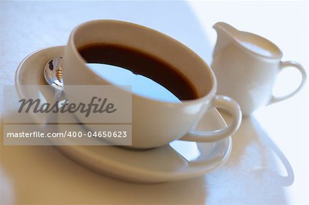 Espresso coffee cup with steel spoon and with cup of milk