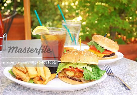 Two burgers on table at outdoor restaurant