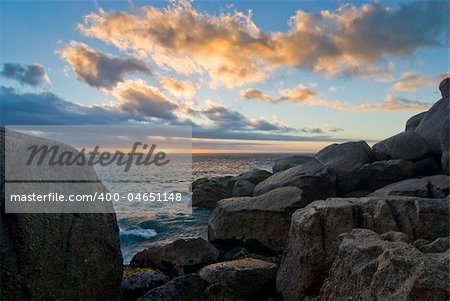 Rocky beach with sunset in the background
