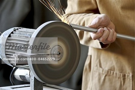 closeup image of manual worker and classic grinder