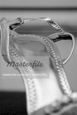 Silver formal wedding shoes, showing details, with focus on heel of shoe