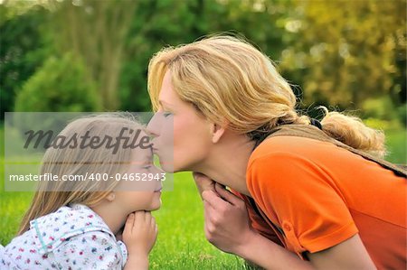 Mother is kissing her daughter