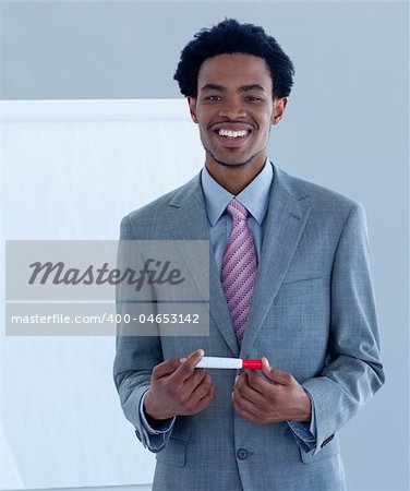 Afro-American businessman giving a presentation to his team