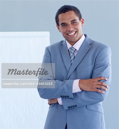 Smiling young businessman giving a presentation on the whiteboard