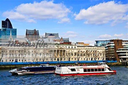 London skyline view from Thames river against blue sky