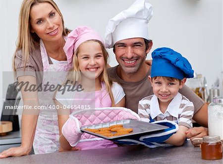 Smiling family baking cookies in the kitchen