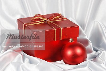 red gift box on white satin background