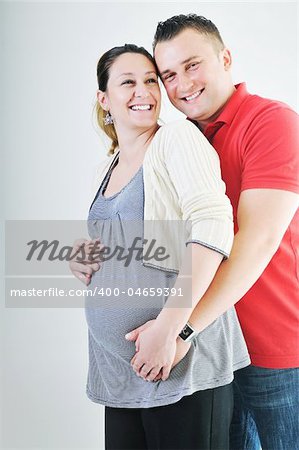 young family couple together in studio isolated on white. happy and waiting for baby