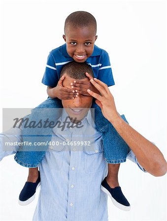 Close-up of a father giving son piggyback ride with closed eyes against white background