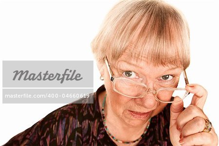 Skeptical senior woman looking over the top of her glasses