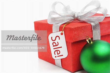 Red Christmas gift with tag and green ornament