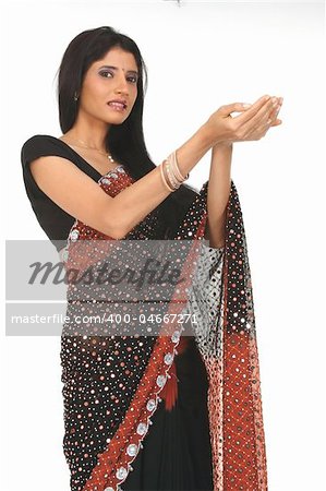 Woman in sari with holding action studio shot