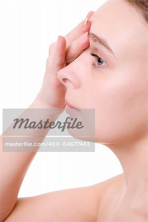 Young beautiful girl applying cream on her forehead over white backgrounf