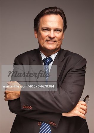 Handsome Businessman Smiling in Suit and Tie Isolated on a Grey Background.