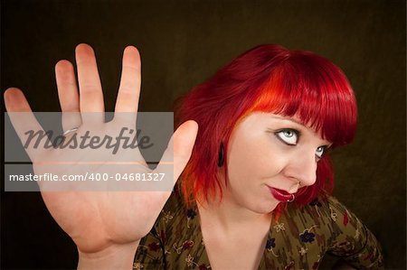 Pretty punky girl with brightly dyed red hair