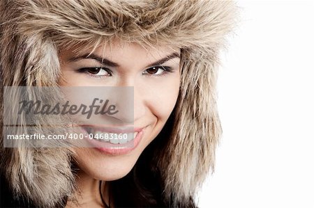 Adorable young woman smiling with a fur hat