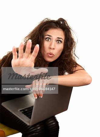 Pretty woman in black with computer seated on orange office chair