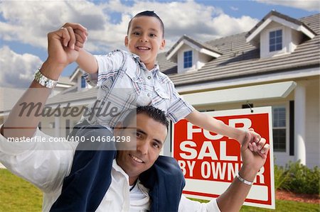 Excited Hispanic Father and Son with For Sale By Owner Sign in Front of House.