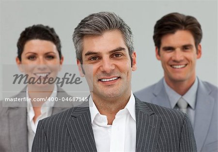 Smiling Business associates standing in a line in front of the camera