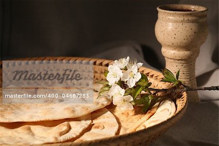 Chalice with red wine and pita bread in a basket