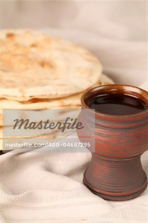 Chalice with red wine and pita bread