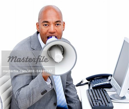 Angry businessman yelling through a megaphone in the office