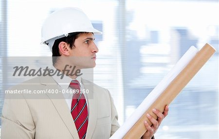 Caucasian architect holding a blueprint  in the company