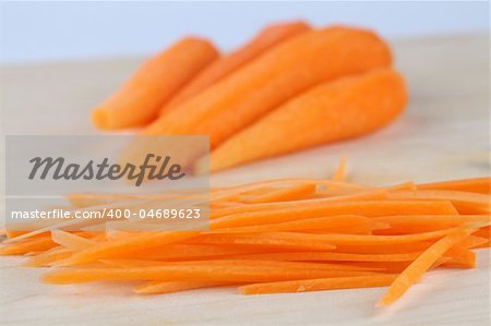 Slices of fresh organic carrot on cutting board