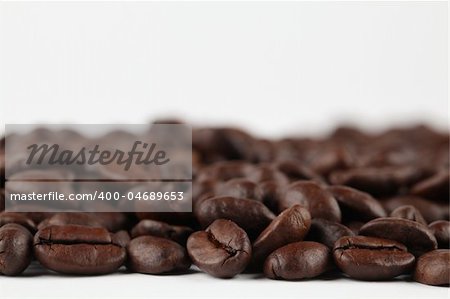 Coffee bean border on white background. Shallow dof