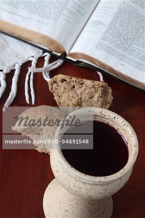 Chalice with red wine, bread and Holy Bible