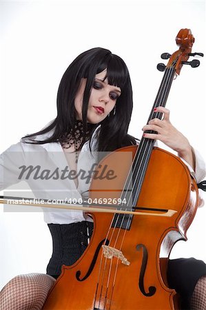 Romantic girl playing cello, studio shot over white background