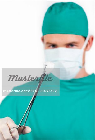 Charismatic male surgeon holding surgical forceps against a white background