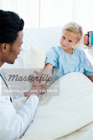 Male doctor giving a child patient an injection in a hospital Male doctor giving a child patient an injection in a hospital