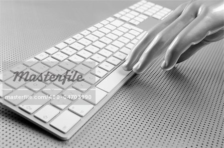 Futuristic silver gray hand and computer keyboard
