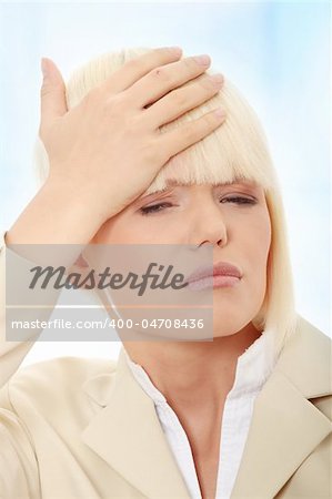 Young business woman with headache,Over abstract blue background