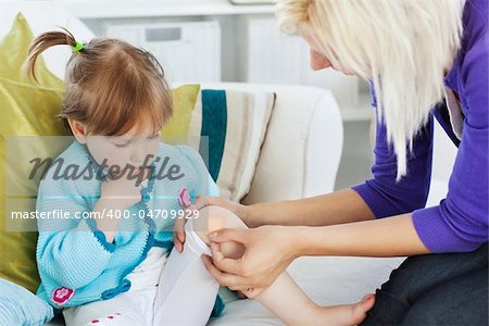 Mother taking care of her injured child at home