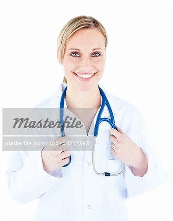 Friendly female doctor holding a stethoscope smiling at the camera against white background